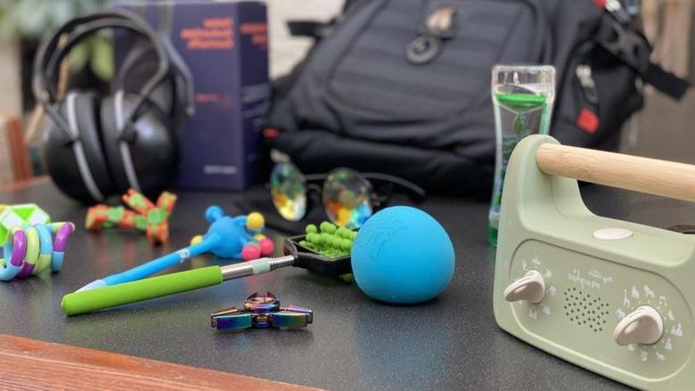 photo of black backpack with sensory tools surrounding it